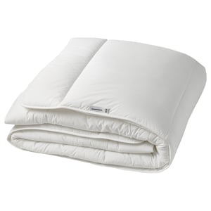 A folded white ikea SKOGSFRÄKEN duvet, neatly placed. Its square-shaped with a soft, quilted design.