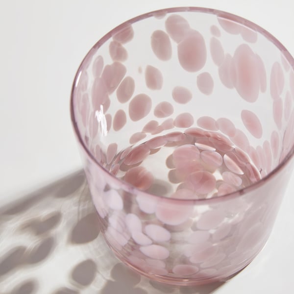 Glass vase with light pink dots, casting dotted shadow. Elegant, high-quality, and decorative.