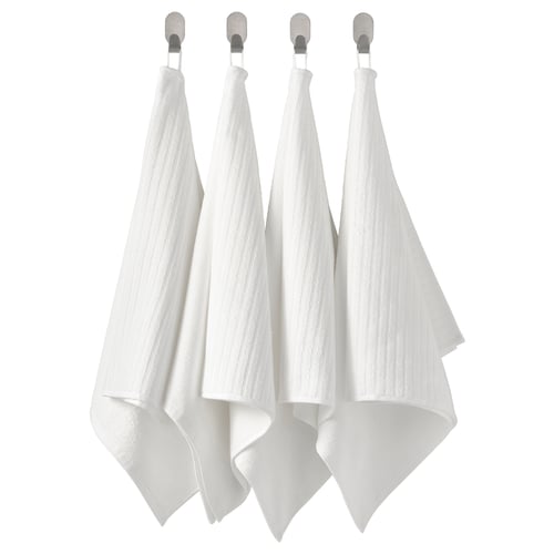 Four white towels hang neatly in a row from hooks. Alternative: four neat white towels hang from silver hooks.