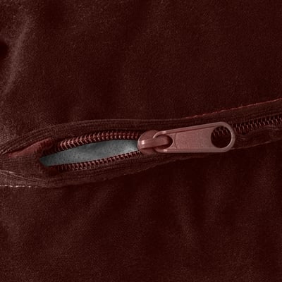 Close-up of durable brown zip on plush fabric, showcasing quality details.