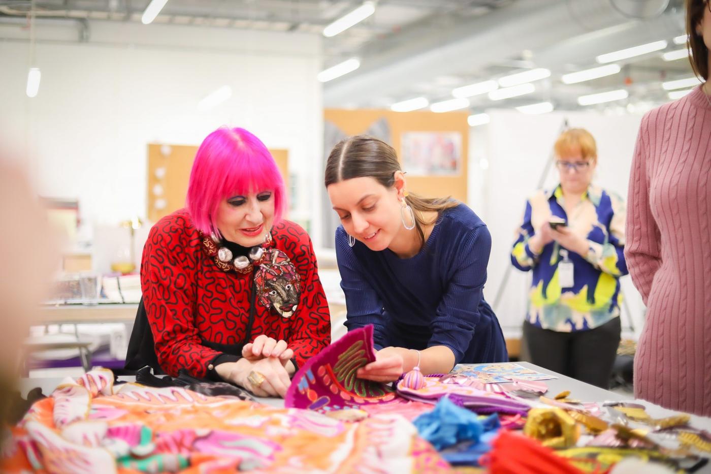 Zandra Rhodes with IKEA designers looking at fabric samples.