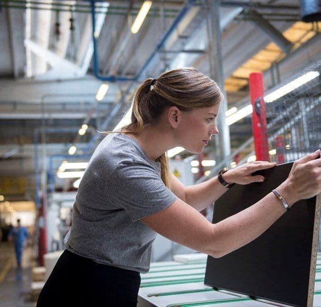 A woman examines a product.