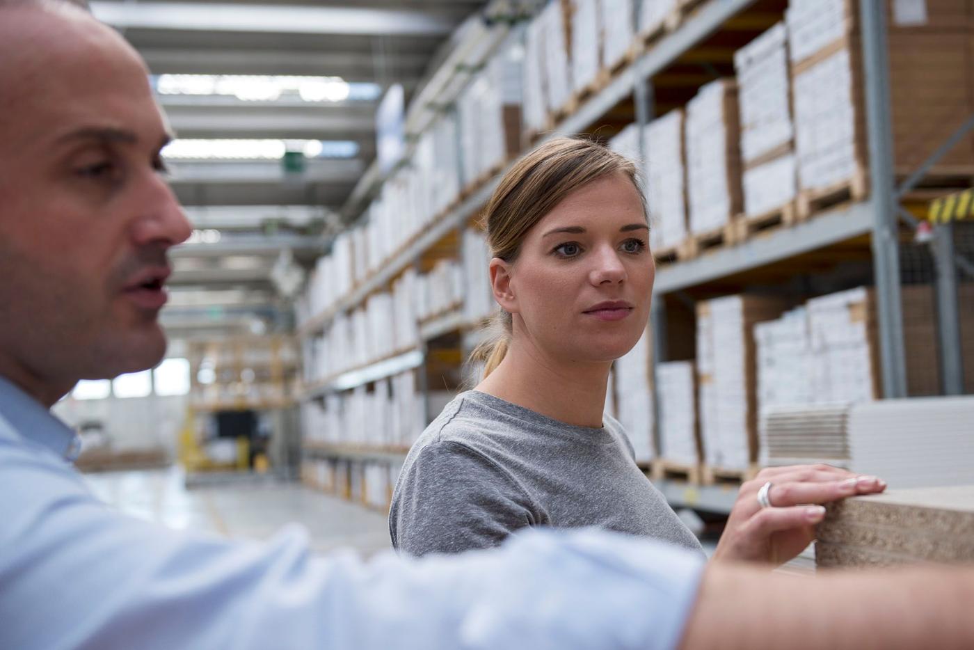 Marco Bergamo, head of development at 3B and Anna Granath, product developer at IKEA, discuss the KUNGSBACKA kitchen fronts at the factory floor at 3B.