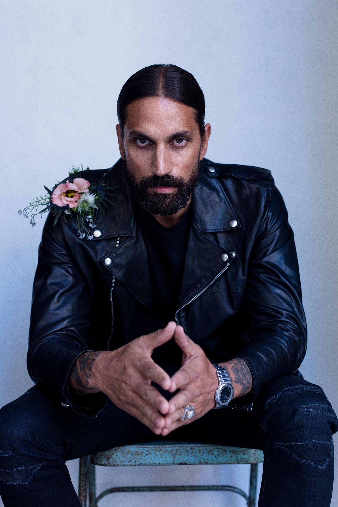 Ben Gorham seated on a chair with hands together, looking into the camera.