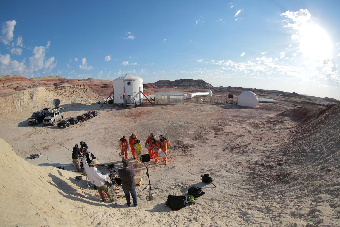 Astronauts training in a desert landscape.