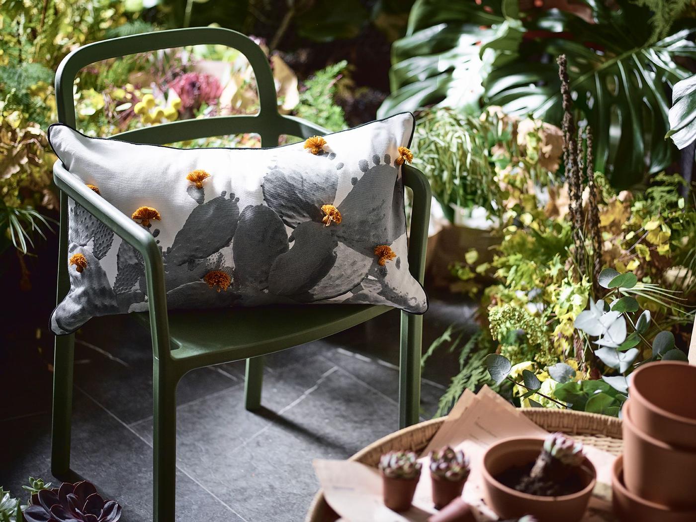 A cushion on a chair in a garden.