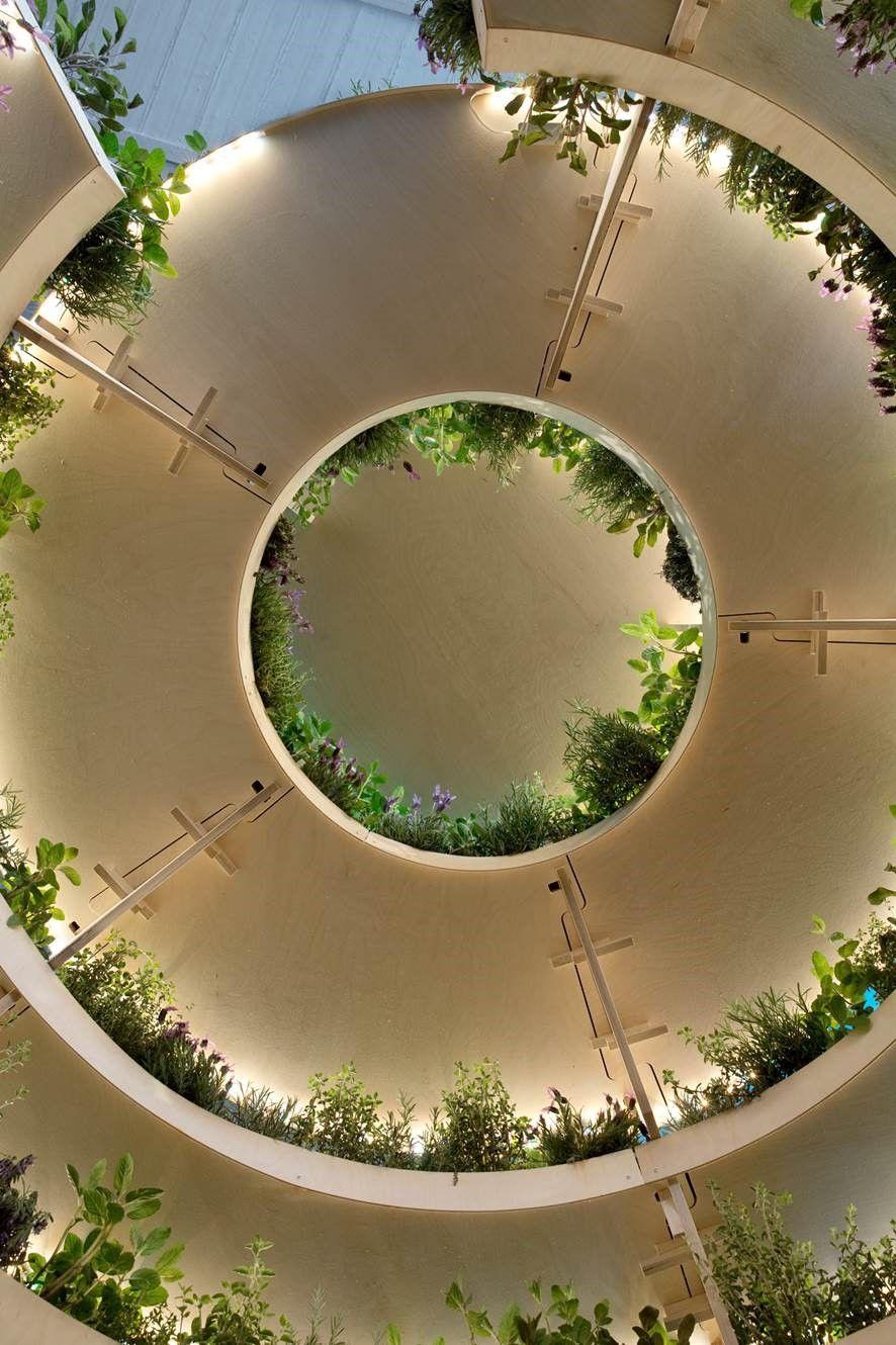 An aerial view of a large circular area with greenery around the walls.