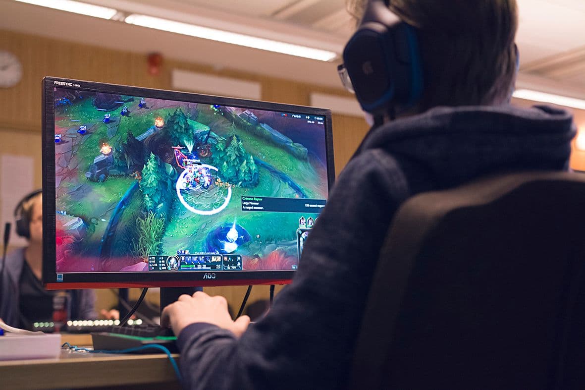 A person gaming at a desk.