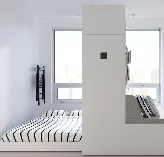 Minimal white space with a bed in black and white striped bed linen.