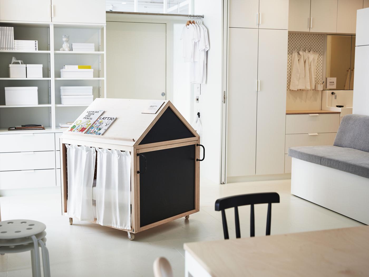 A small playhouse in a white living area.