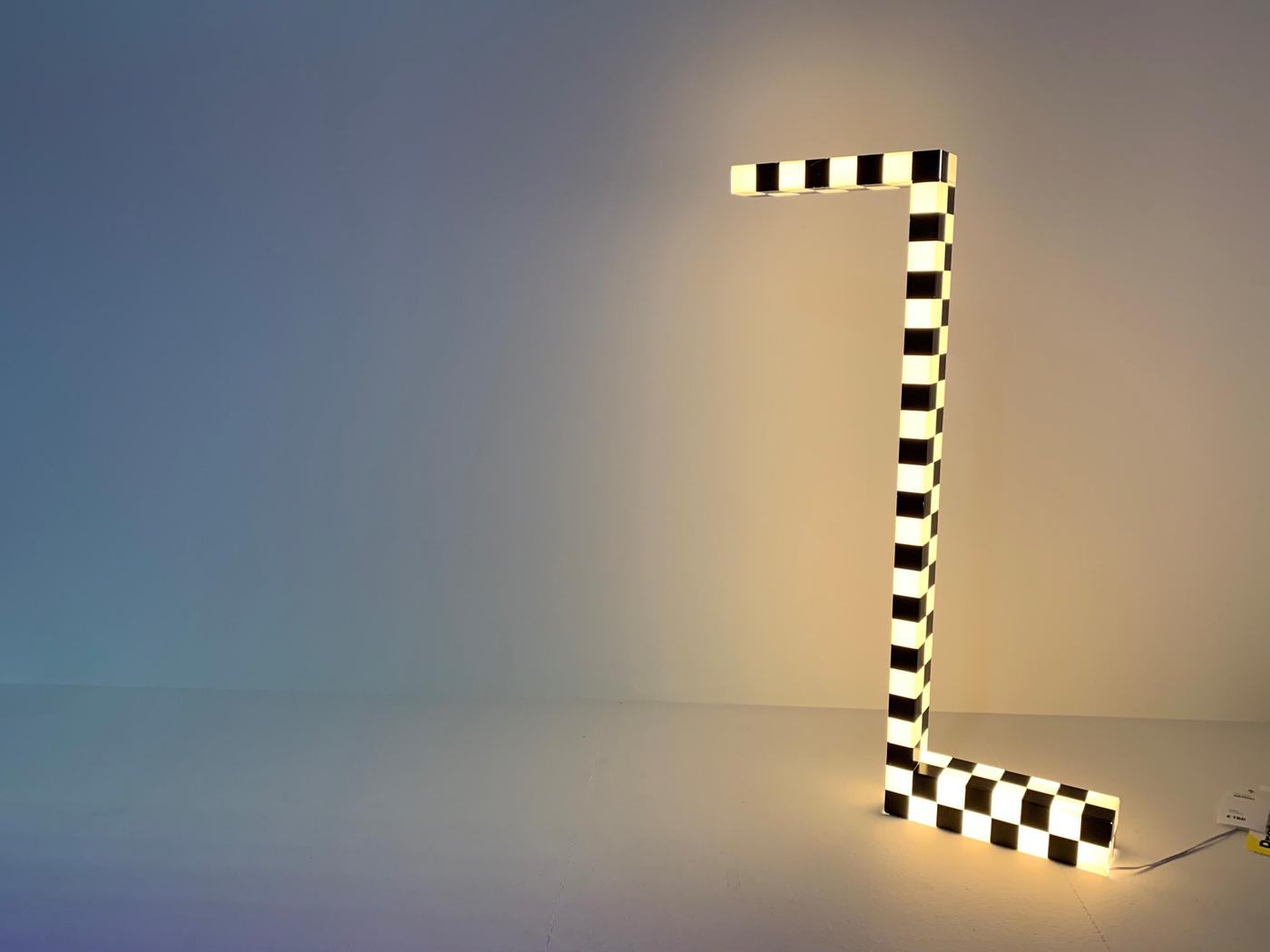 A black and white Z shaped illuminated lamp.