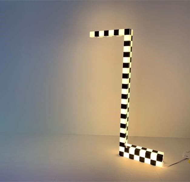 A black and white Z shaped illuminated lamp.