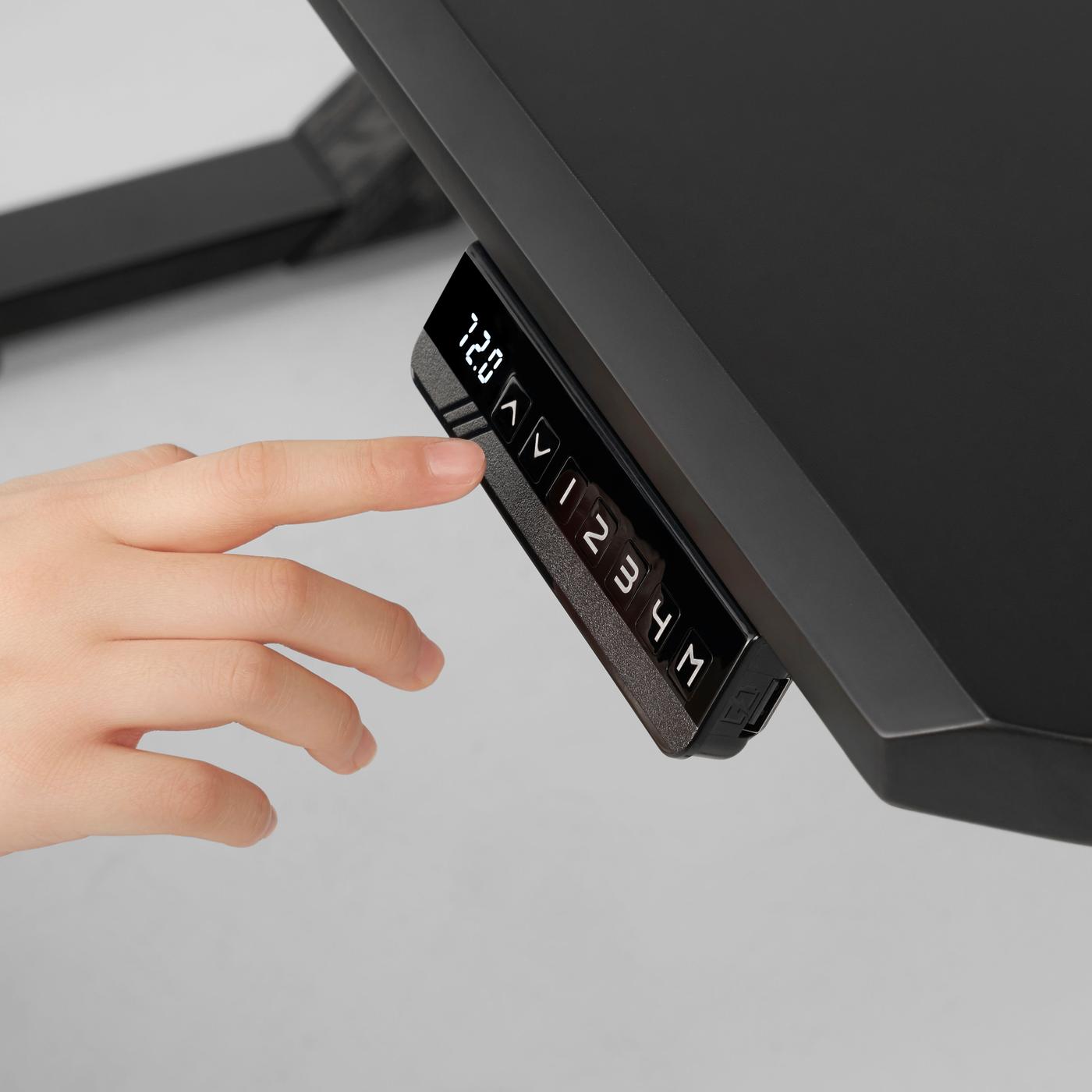 A hand chooses a button on the black gaming desk.