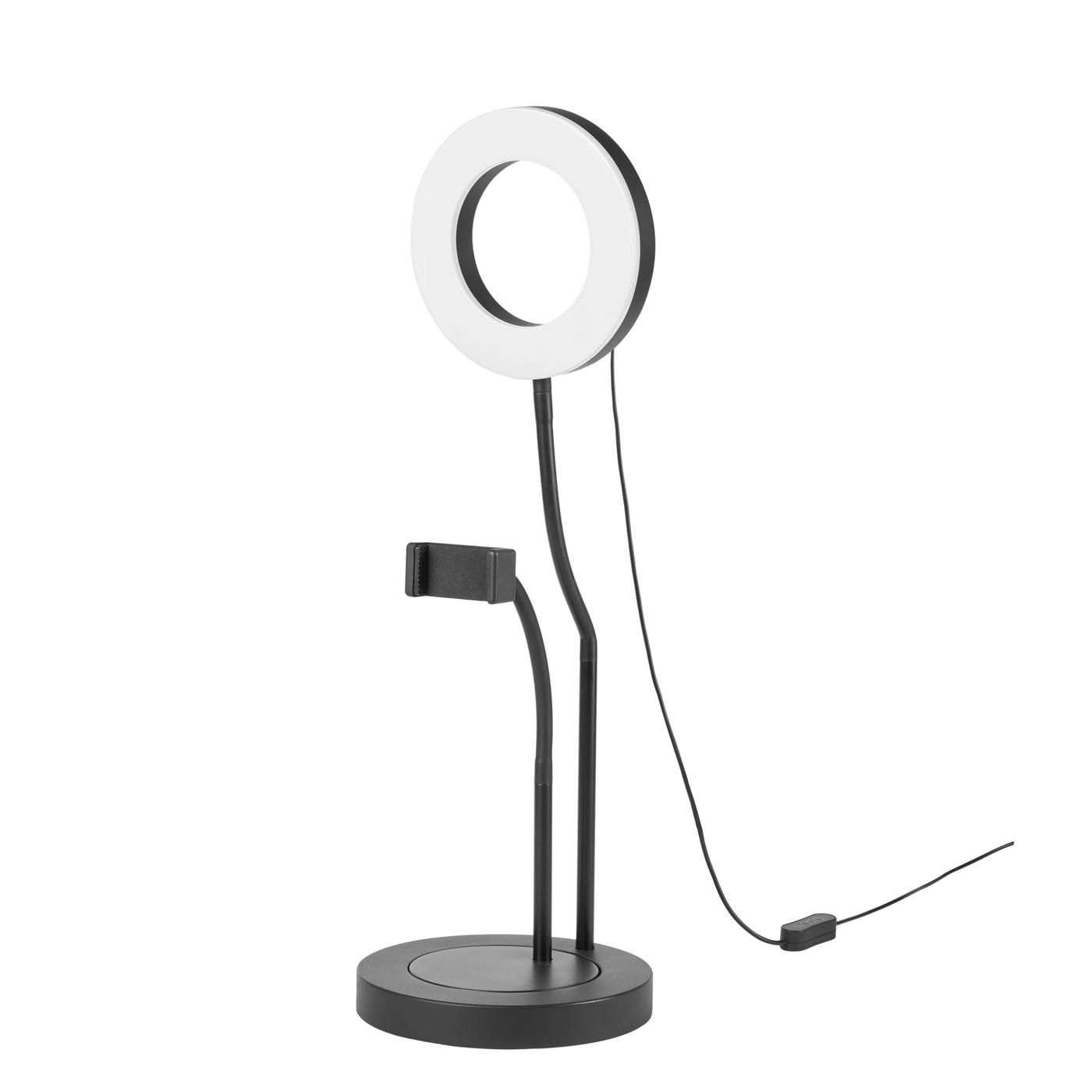 A ring light switched off, with phone holder in black against a white background.