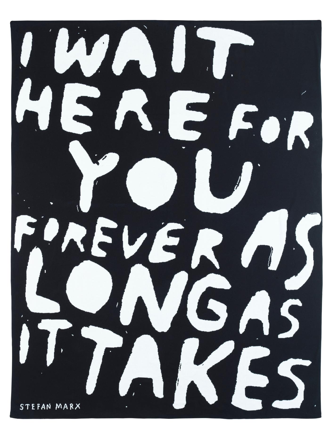A black throw with the white writing "I wait her for you forever as long as it takes".