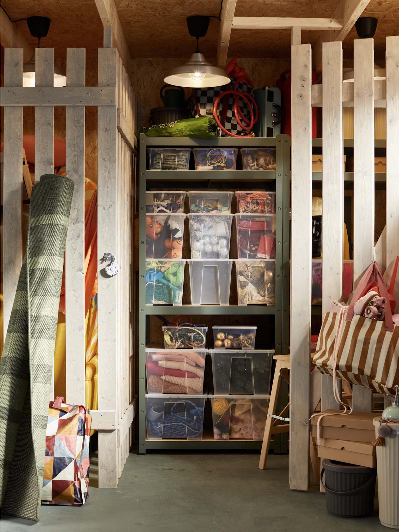 A neatly organised storage area with many clear bins on a shelving unit.