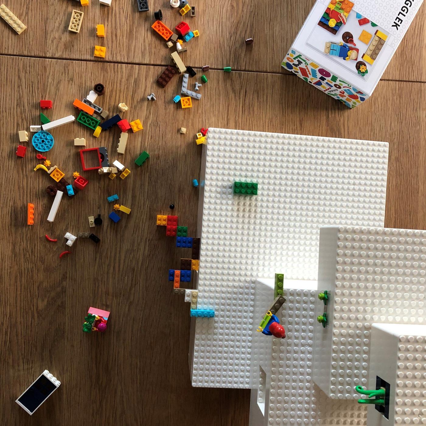 White BYGGLEK LEGO boxes, a cardboard packaging box and brick set on a floor.