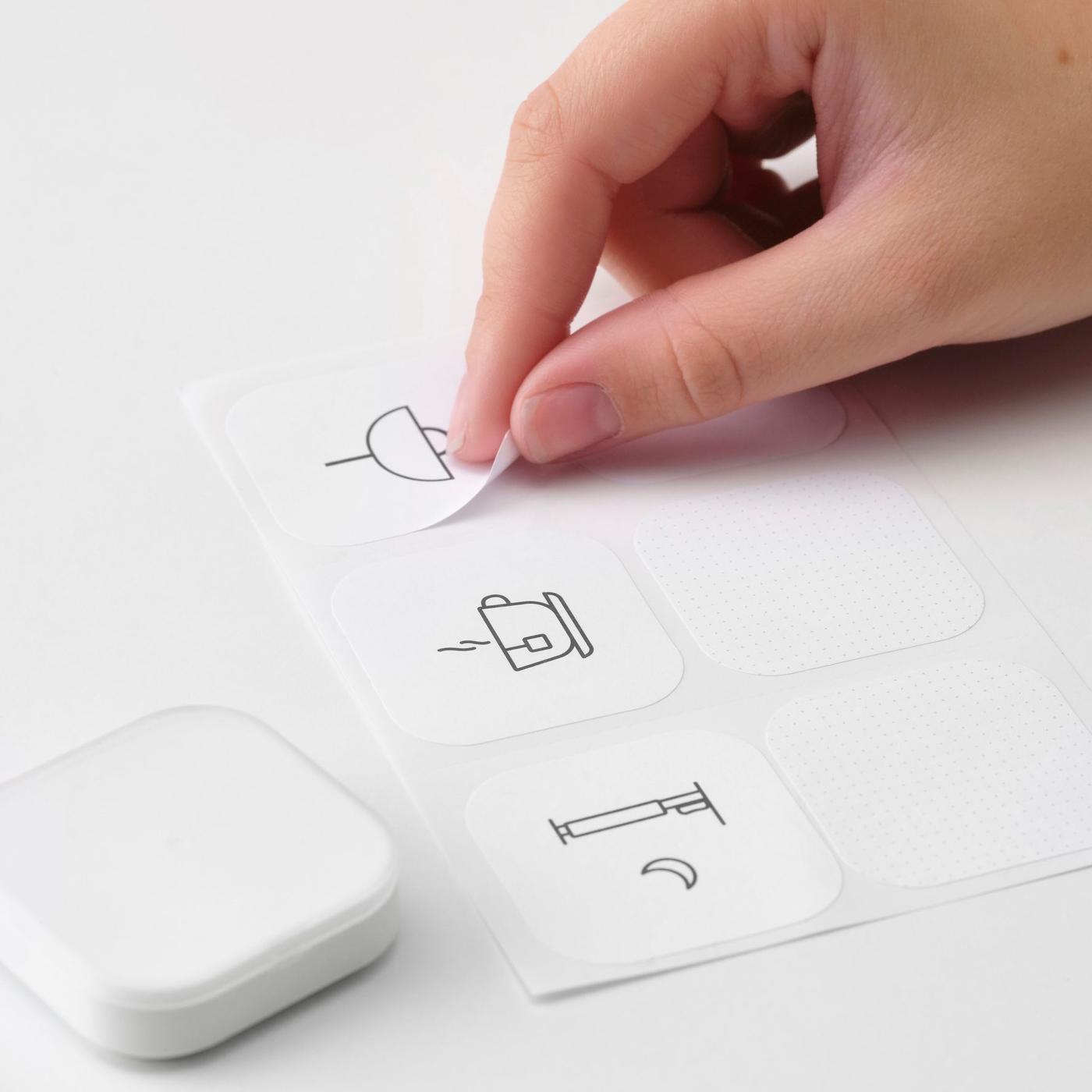 A hand peeling off stickers and a TRÅDLÖS remote control.