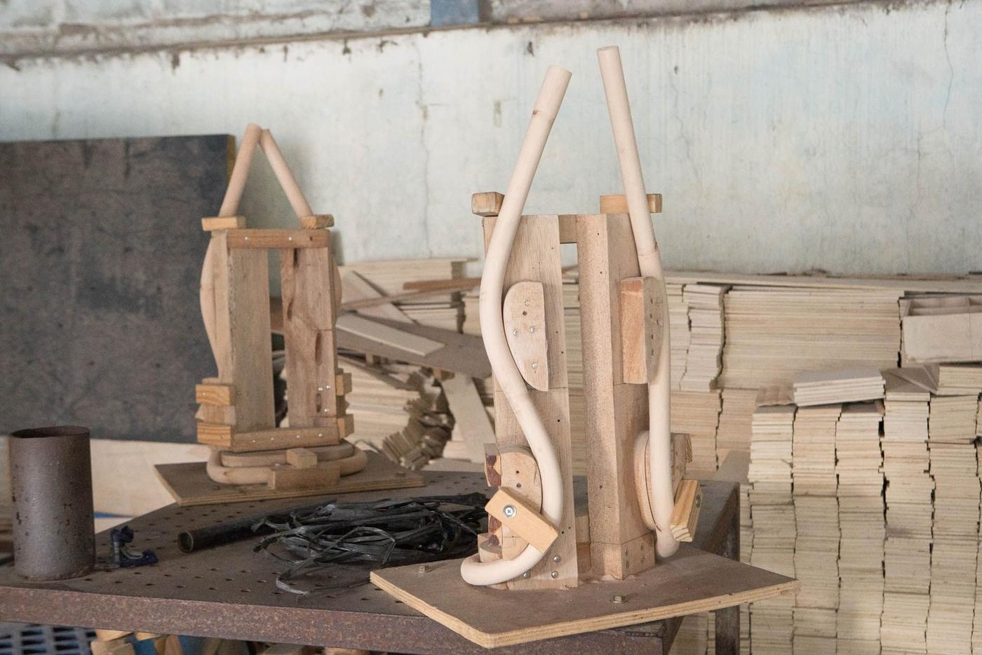 A room with rattan canes on a work surface being moulded into shape.