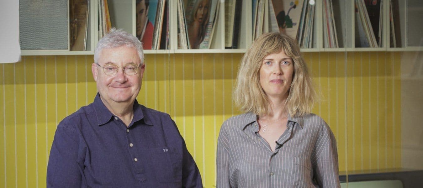 Anna Sandberg Falk and Per Hahn in front of a 70's wall at IKEA Museum.