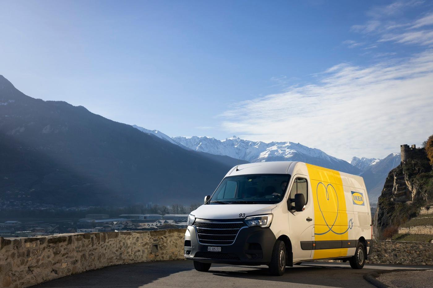 An IKEA EV delivery van driving through a mountainous landscape.