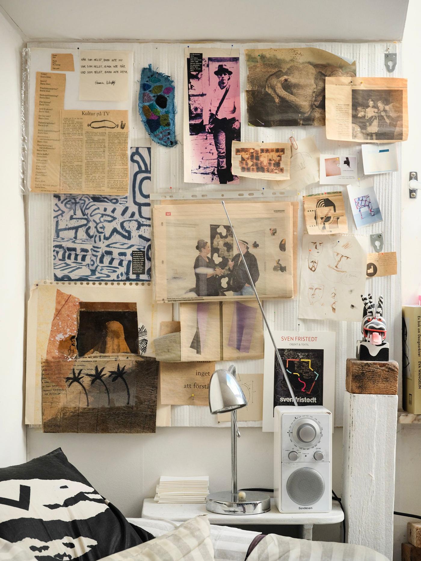 A wall with sketches and clippings from newspapers.