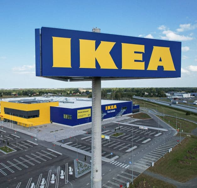 The facade of an IKEA store, with a sign with the IKEA logo.