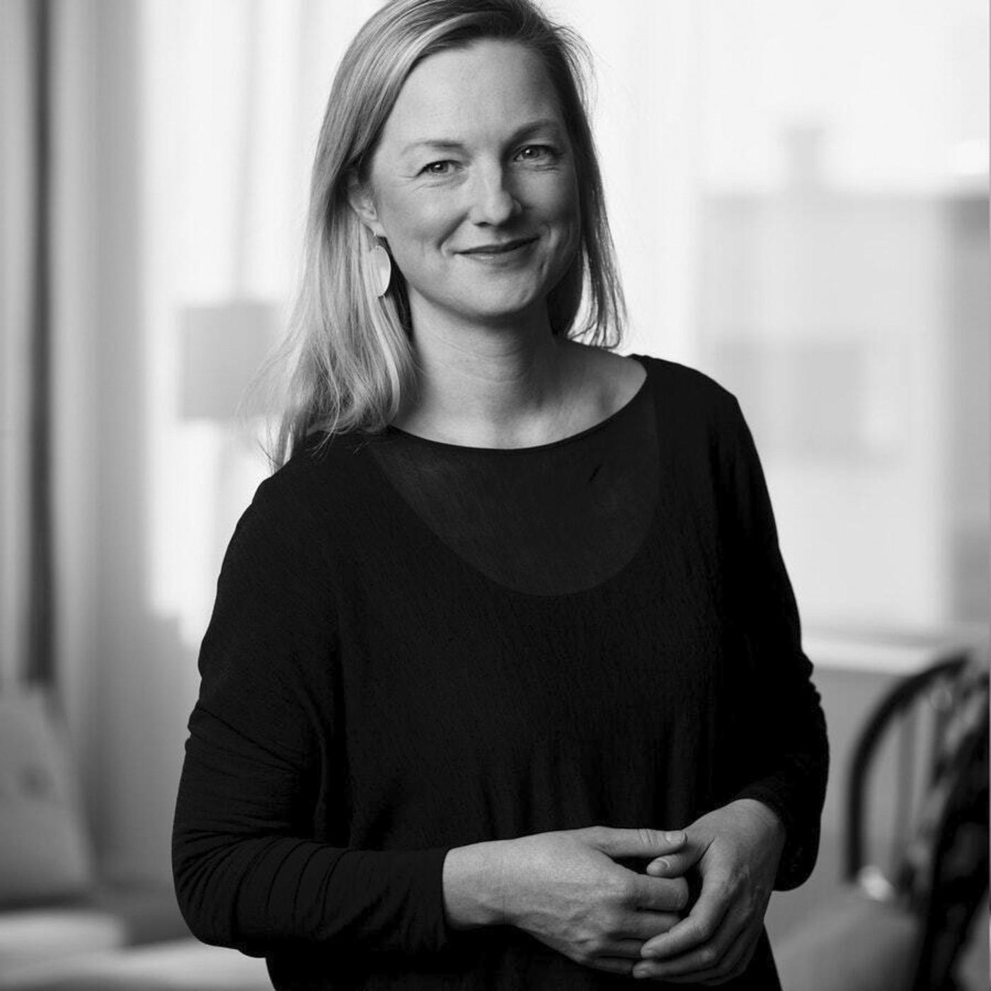 A black and white portrait of a woman in a black shirt.