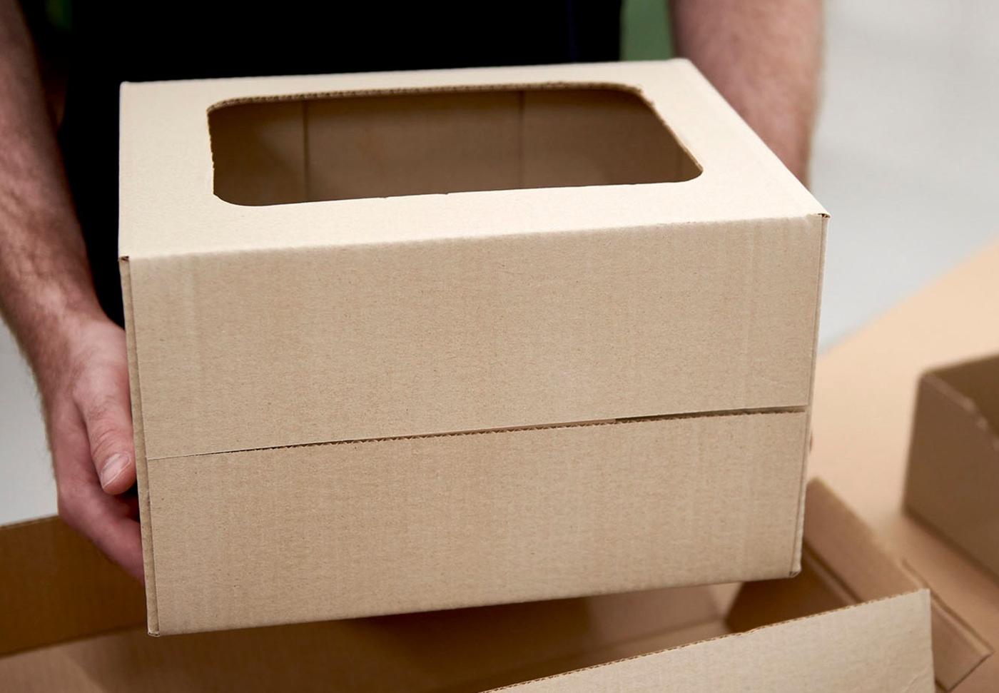 A man handing a cardboard box.