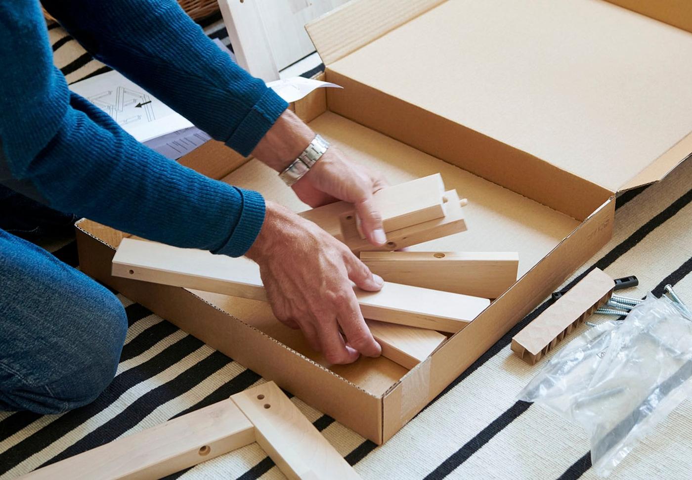 Two hands unboxing an IKEA package.