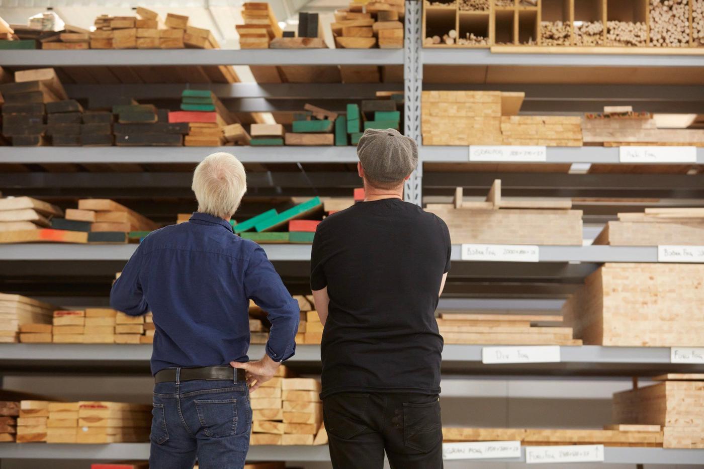 Two men standing in a workshop. 