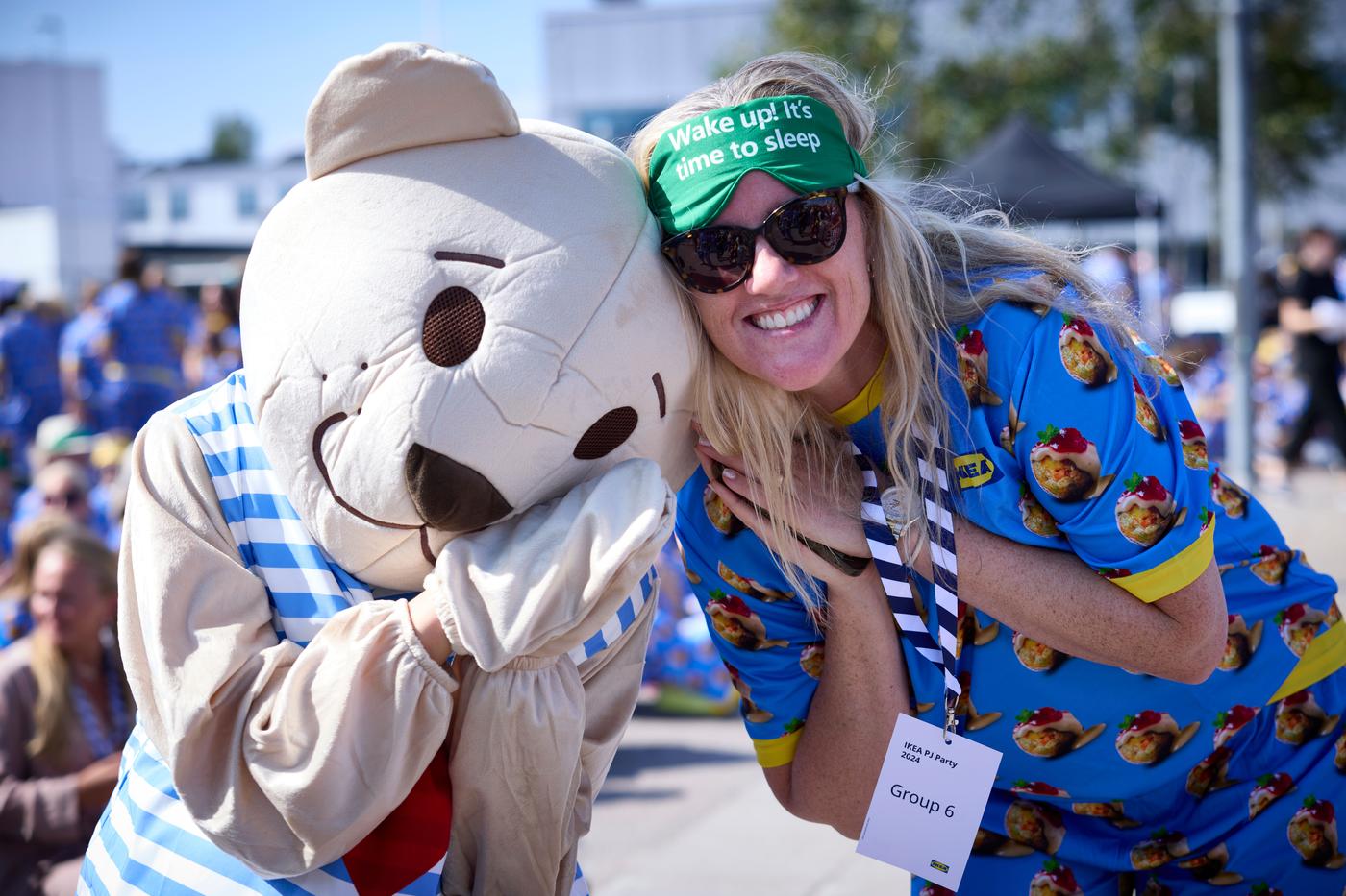 A person in bunny costume and person with green sleeping mask are posing