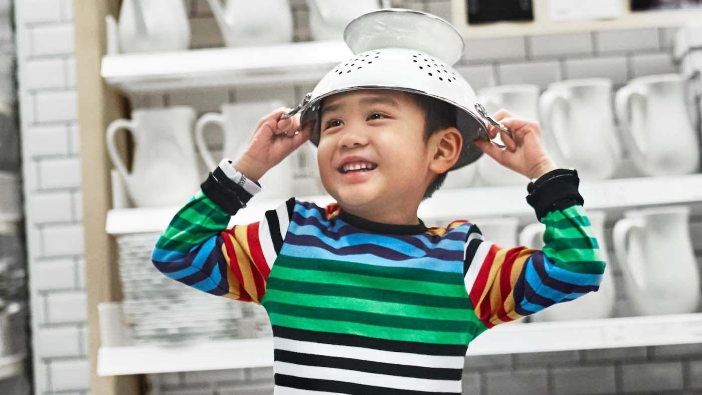 A photo of a child with a colander on their head with the words IKEA 2017 by numbers superimposed on the photo.