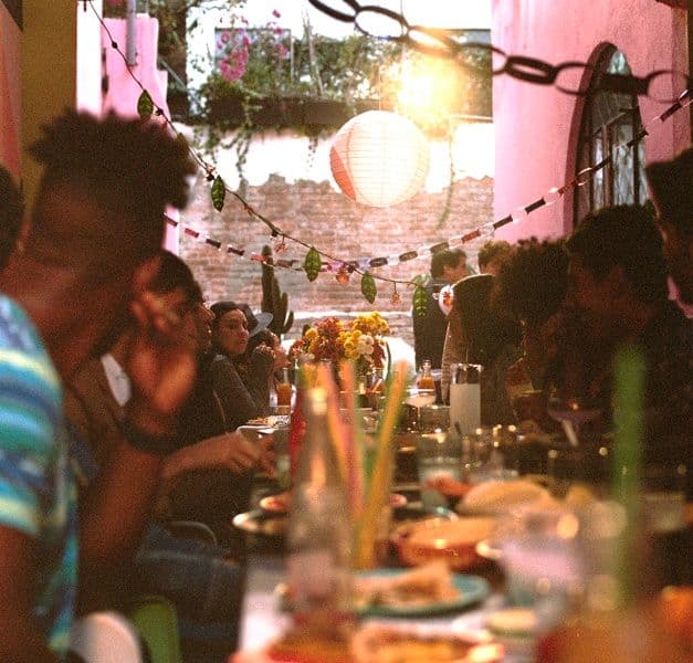 People sitting around a dining table set with festive decorations.