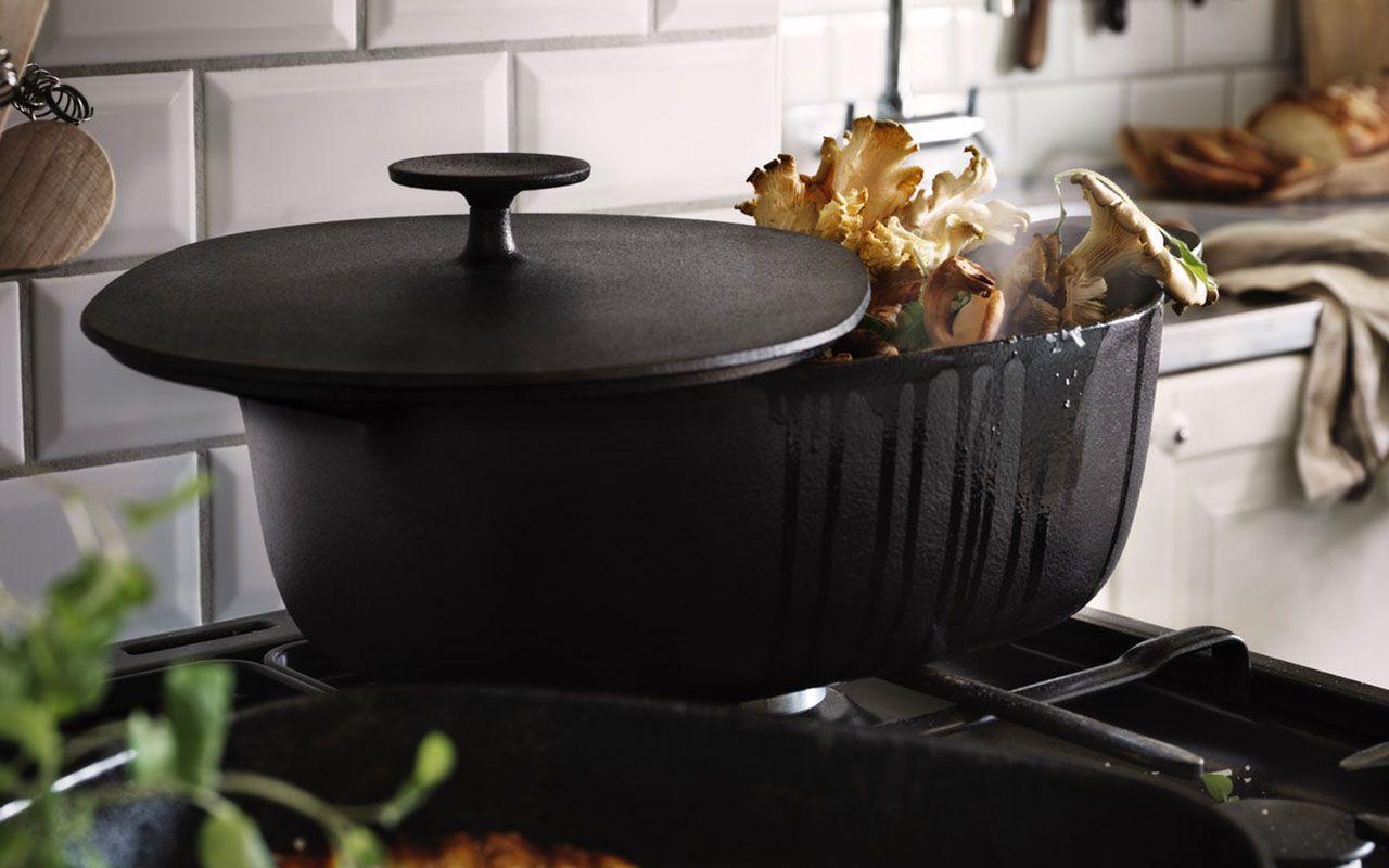 A VARDAGEN casserole with lid filled with boiling mushrooms on a stove.