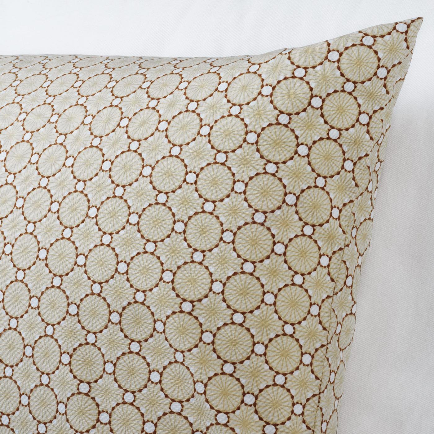 The angle of a cushion with a classic beige and brown, fairly small pattern.