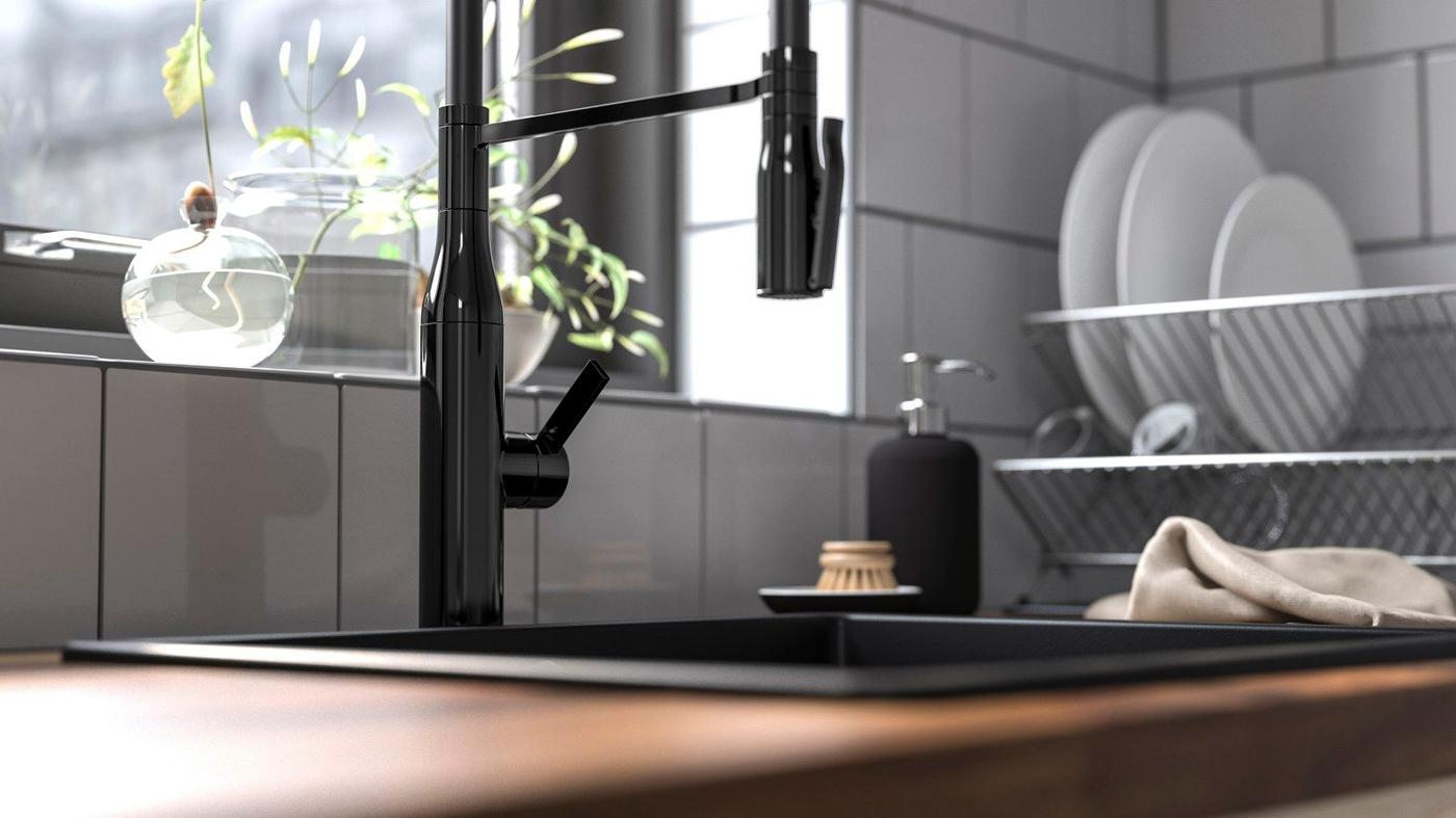 A TOLLSJÖN kitchen mixer tap with hand spray in a white and wood kitchen.