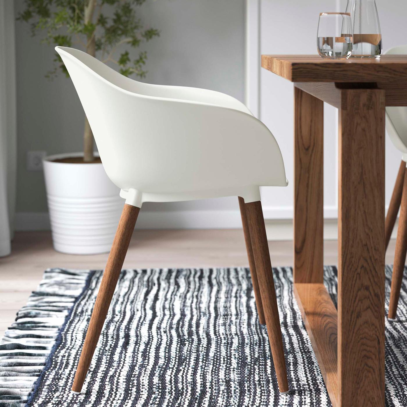 A white GRÖNSTA chair next to a table.