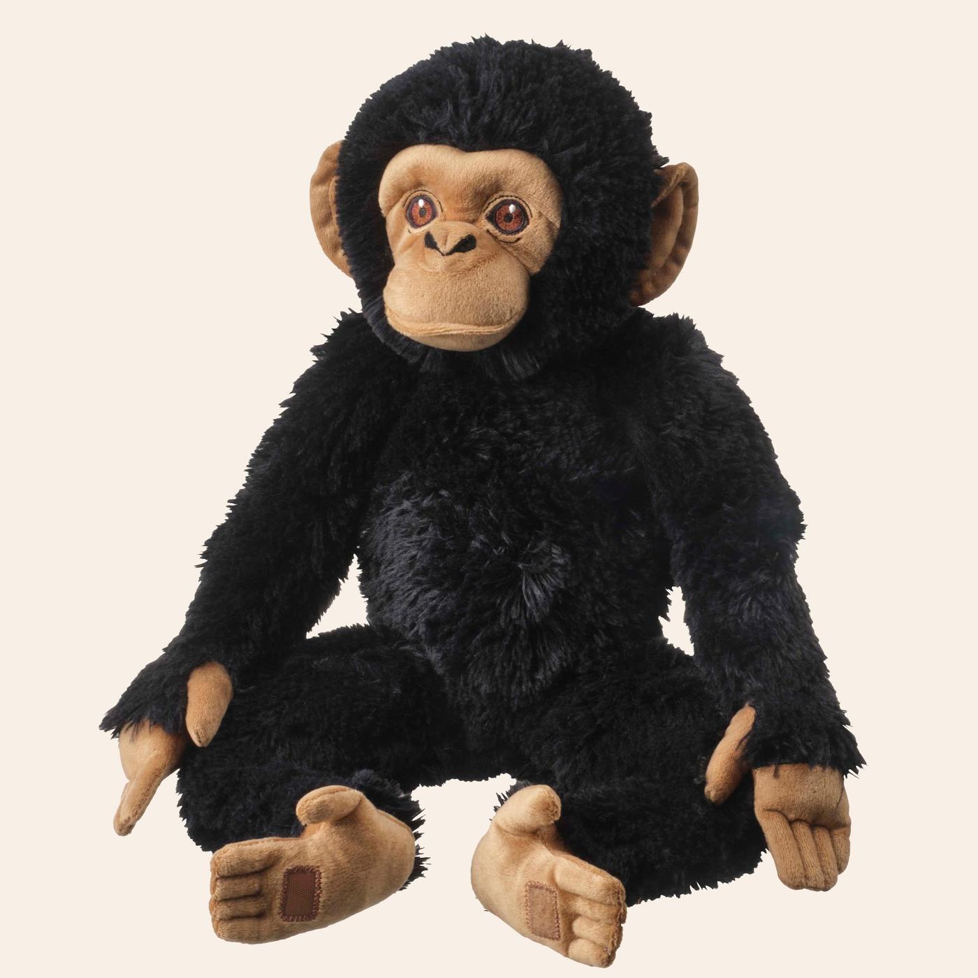 A cutout of the SANDLÖPARE soft toy chimpanzee sitting up.