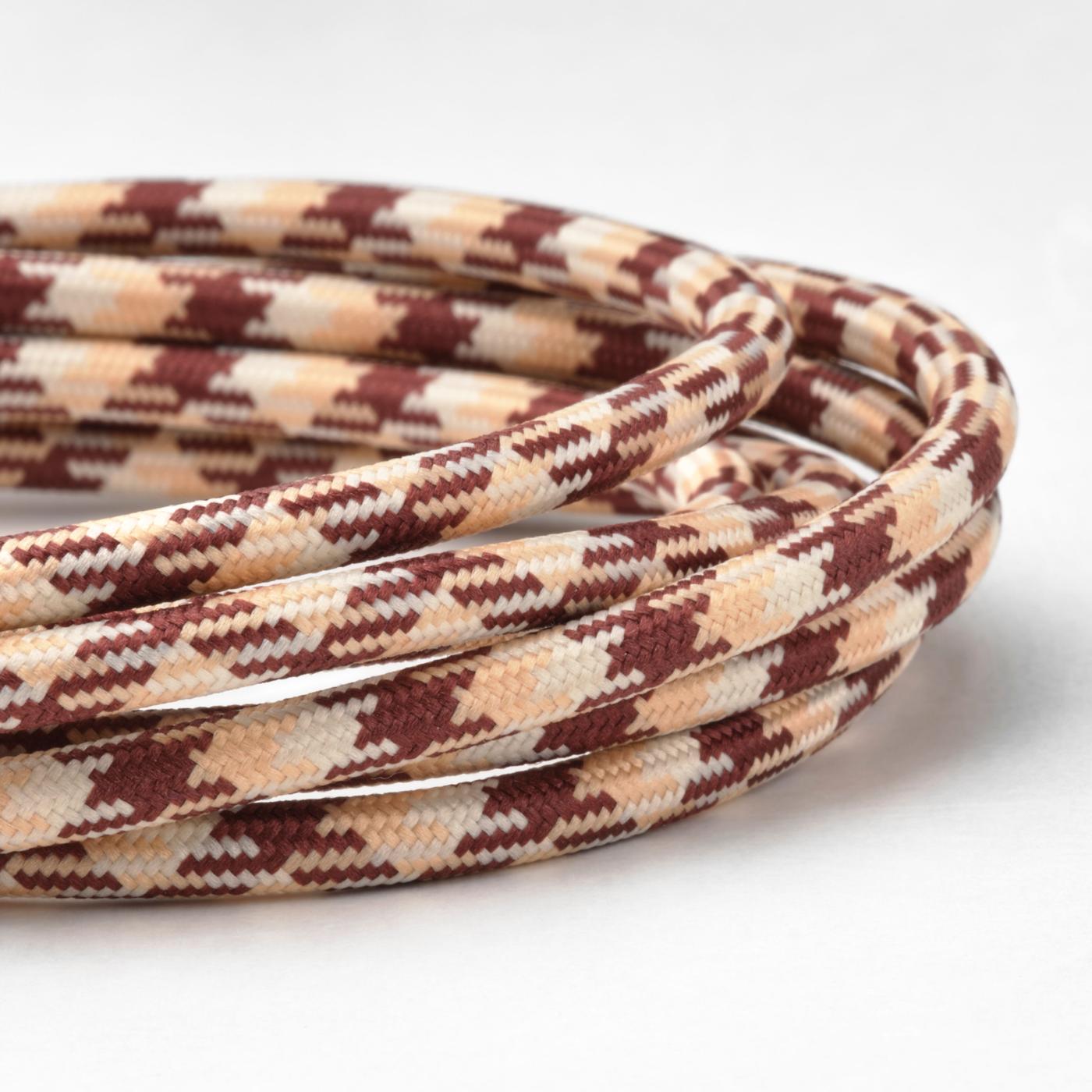 Close-up of patterned and textured charging cable in beige and reddish-brown tones.