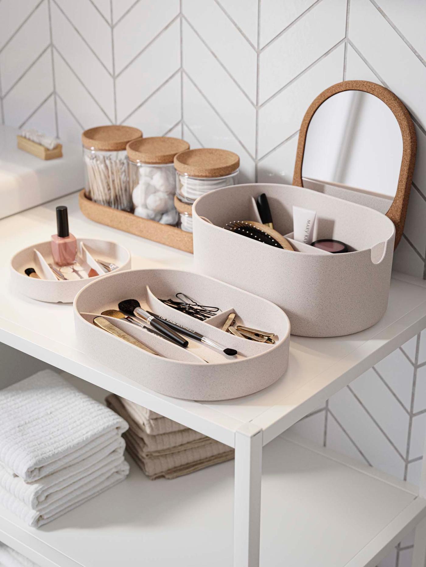 Matching containers filled with beauty tools and cleansing pads on a shelf.