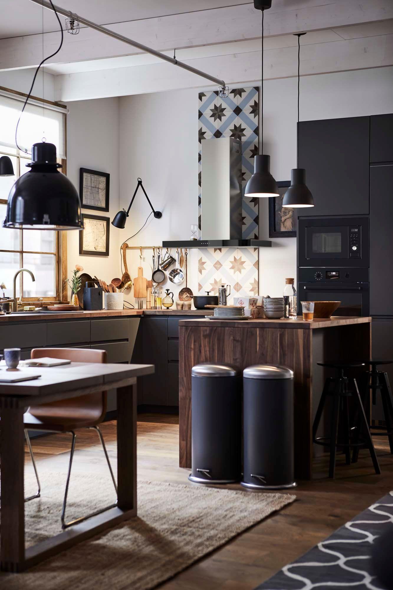 An open-plan kitchen with an island and a dining table.