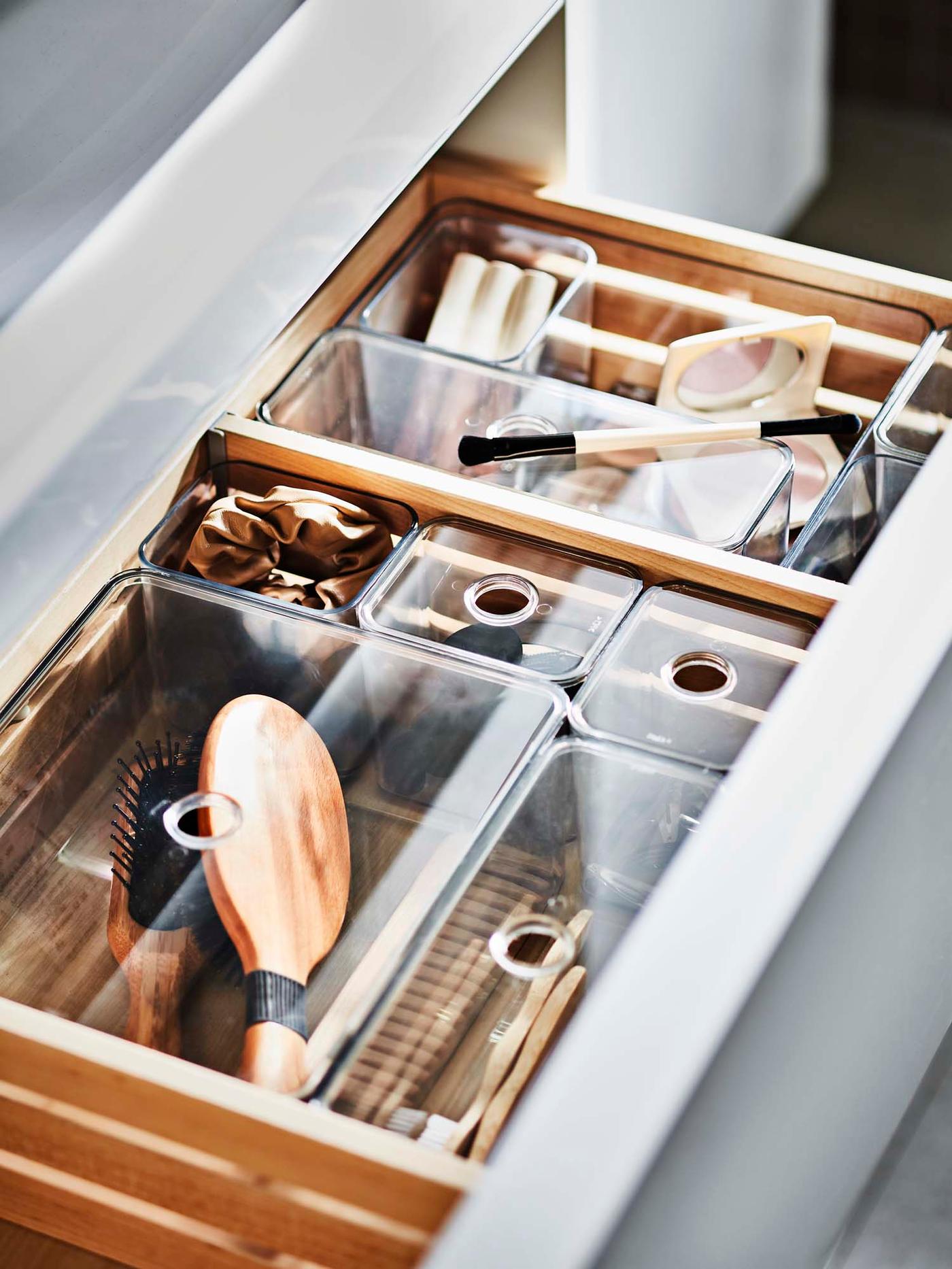 Drawer dividers organise beauty products in an open drawer.