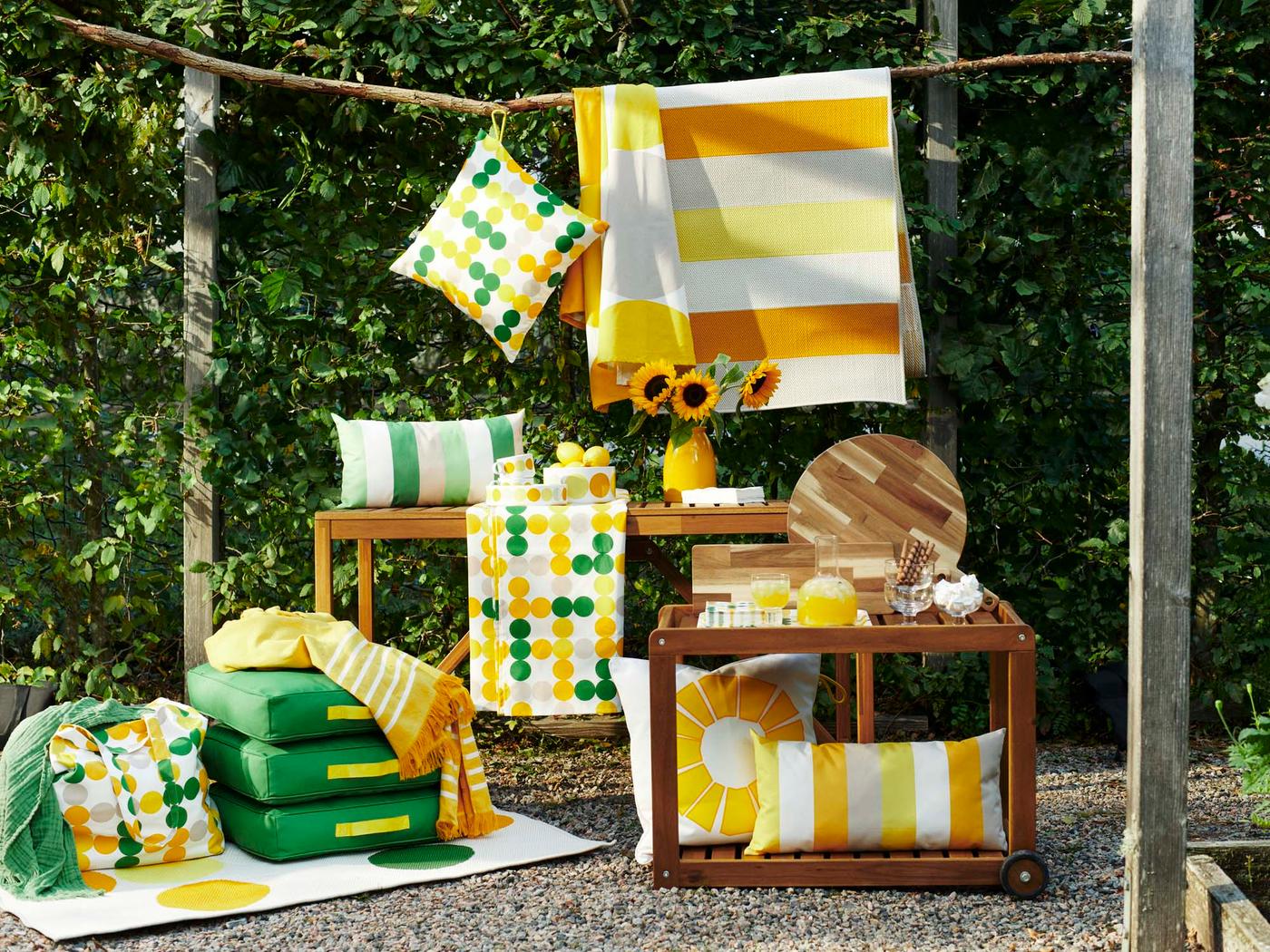 An outdoor, lush area with a display featuring products from the BRÖGGAN collection.