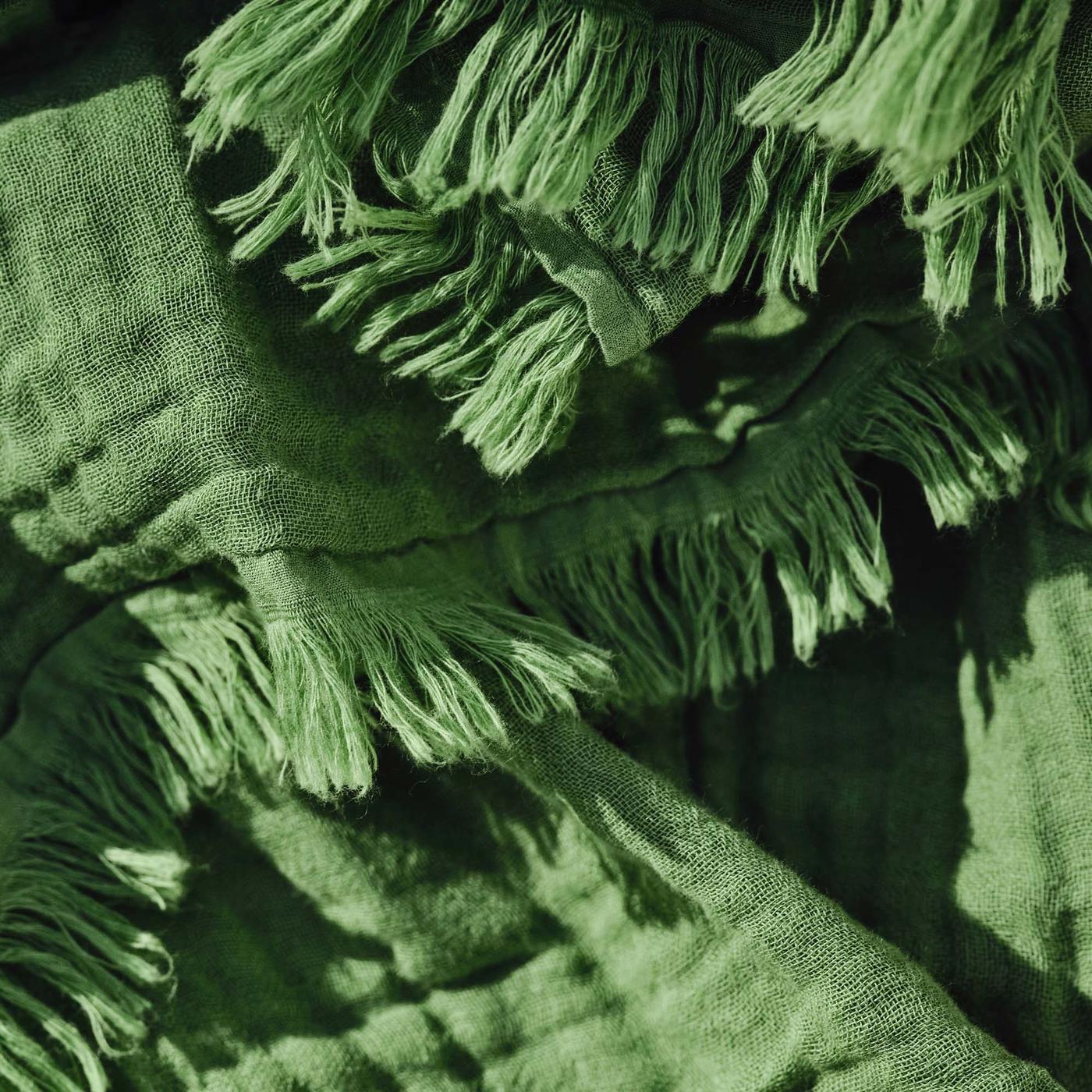 A close-up of a green BRÖGGAN throw.
