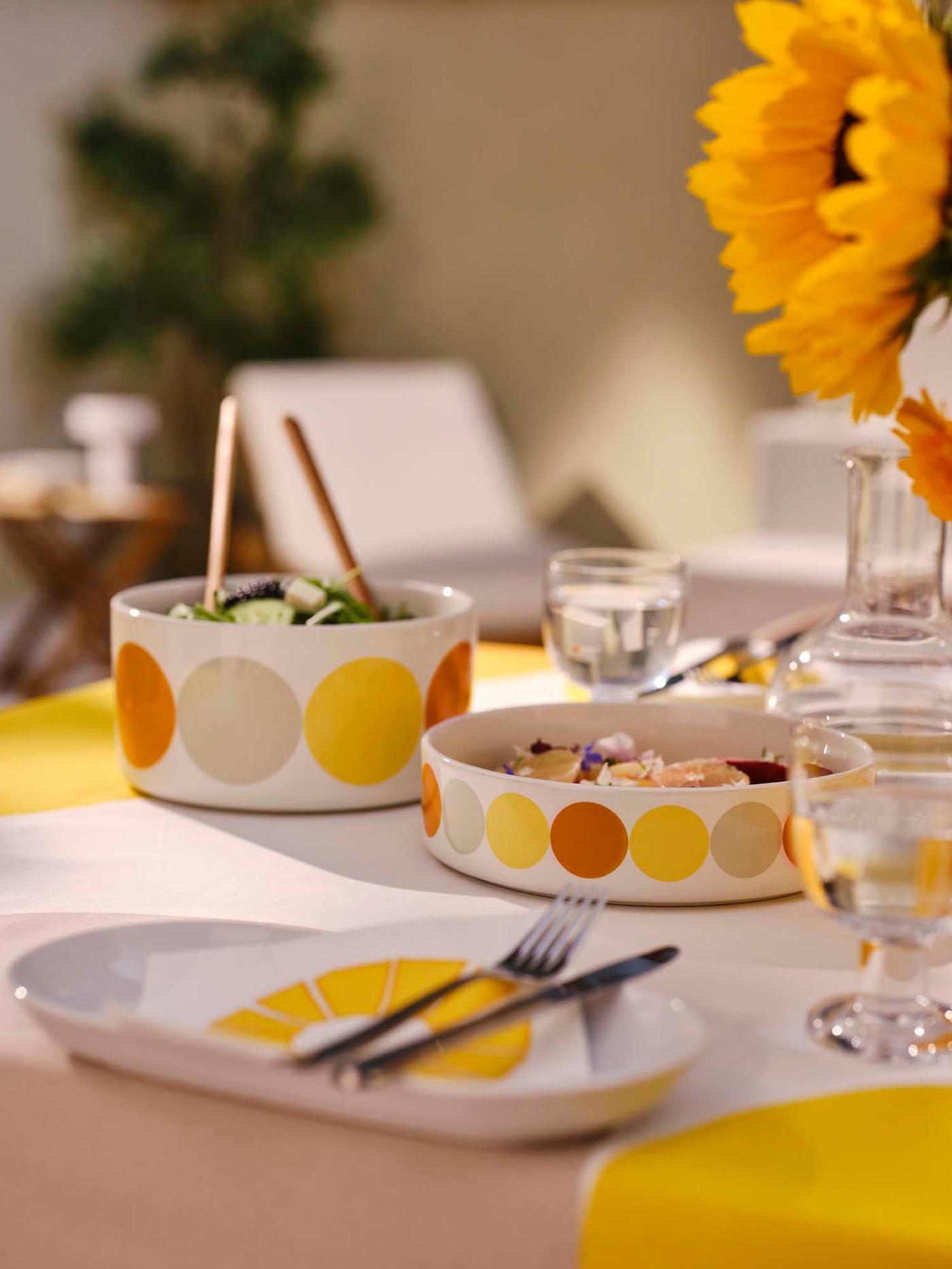 BRÖGGAN bowls filled with food on a table dressed in a BRÖGGAN tablecloth.
