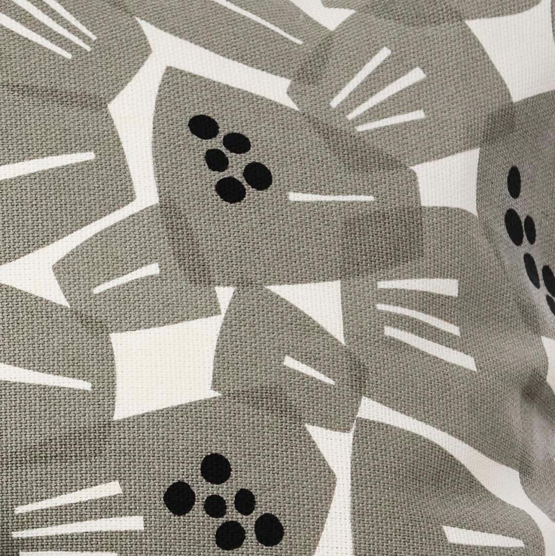 A close-up of a grey floral print cushion cover.