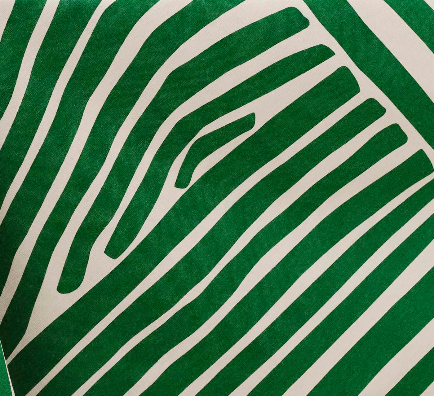 A close-up of a cream and green stripe tablecloth.