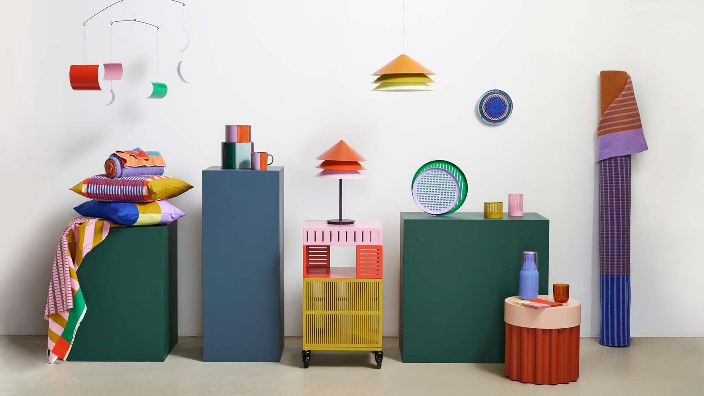 A collection of brightly coloured products from the TESAMMANS collection sitting on plinths