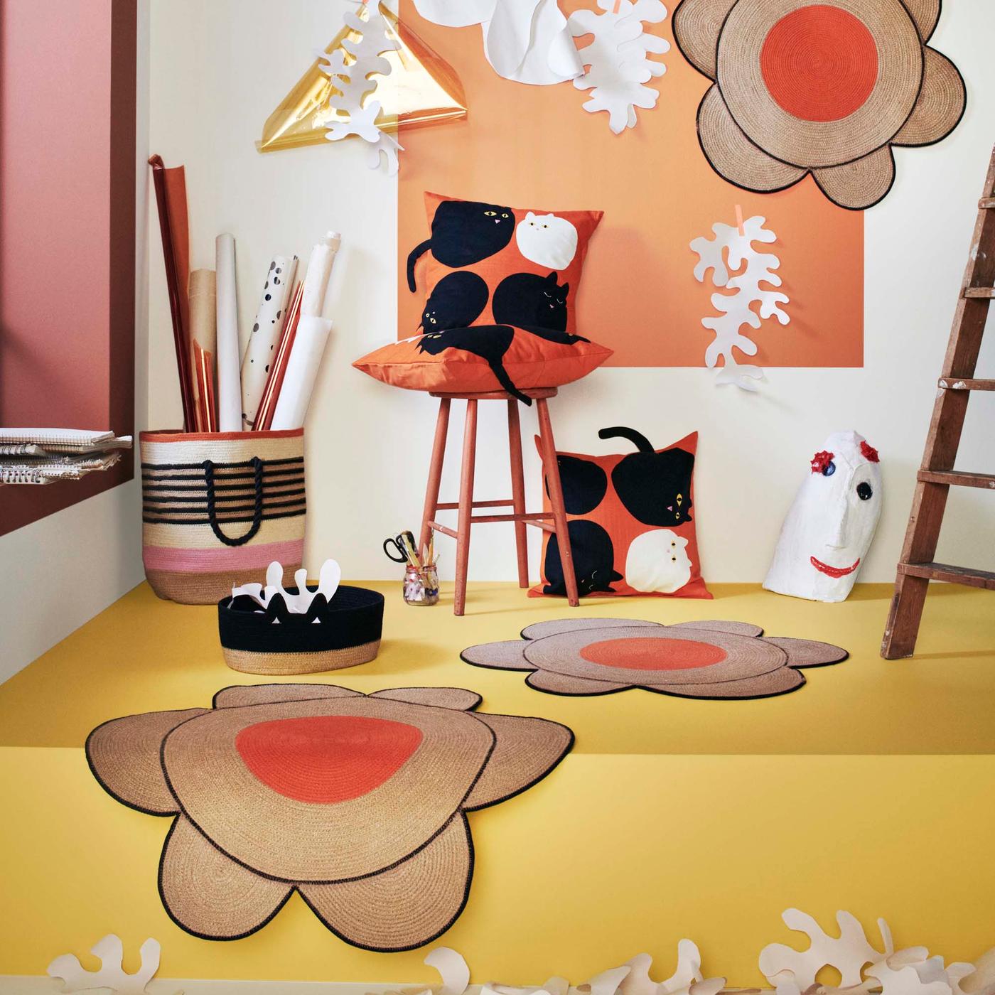 Handmade products from the MÄVINN collection displayed playfully in the corner of a white room set with yellow floors.